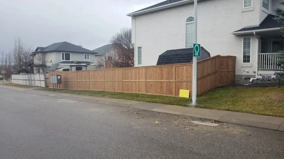 Long new wood fence along a residential street