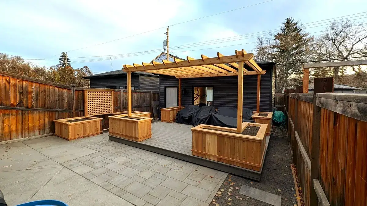 Cedar pergola over a paved patio with planter boxes